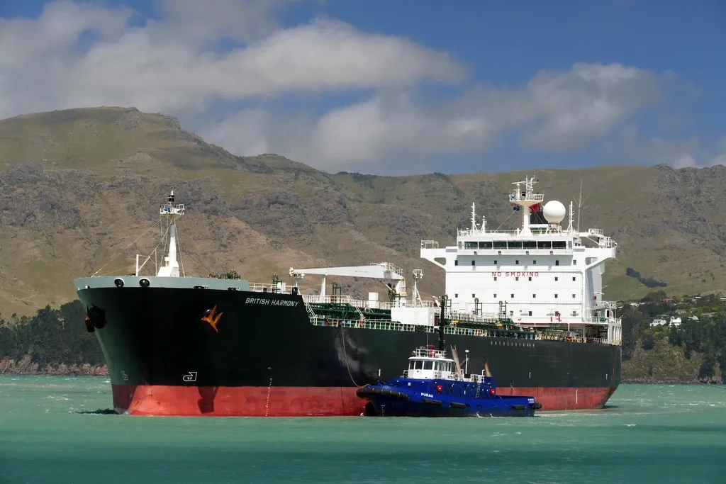 Tanker ship with a tug in a harbour