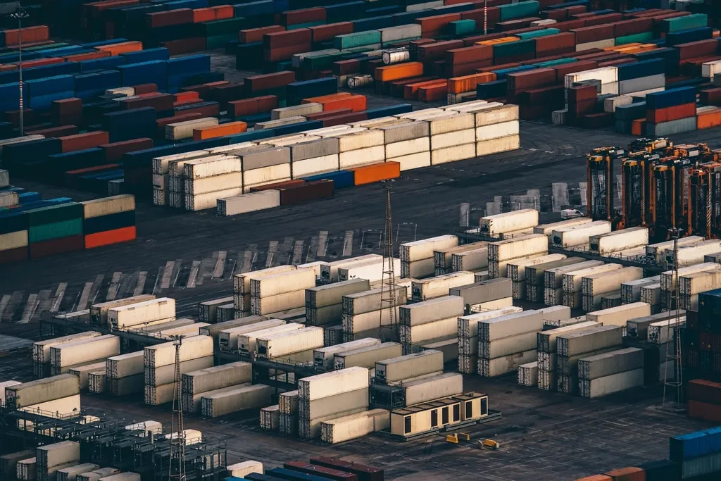 Aerial view of stacked shipping containers in a port container yard